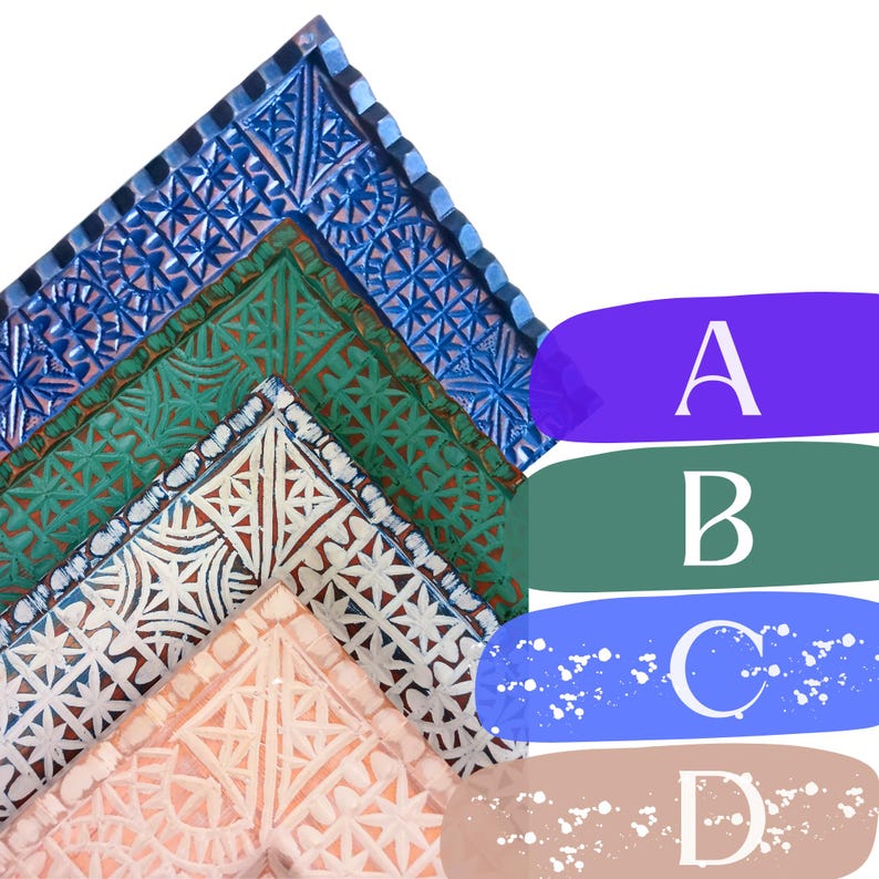 May include: Four wooden picture frames with intricate carved designs. The frames are layered on top of each other, with the top frame being blue, the second green, the third white, and the bottom frame being pink.