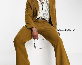 May include: A mustard yellow suit with a blazer and flared pants. The blazer has a notched lapel and a single button closure. The pants have a high waist and a wide leg.