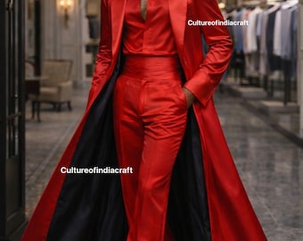 May include: A vibrant red satin suit, consisting of a long coat with a black lining, a button-down shirt, and matching trousers. The outfit is a bold fashion statement, perfect for formal events. The text "Cultureofindiacraft" is visible.