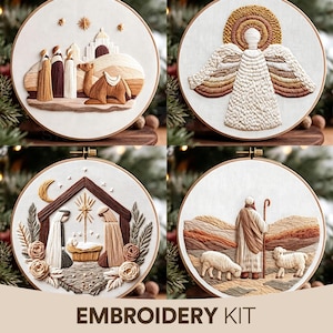 May include: Four circular embroidery hoops featuring religious scenes in neutral earth tones. Designs include figures traveling with a camel, a winged angel with a halo, a nativity scene with a manger, and a shepherd with sheep. Text reads EMBROIDERY KIT.