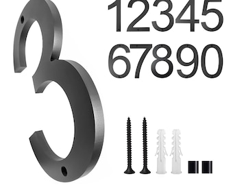 May include: Black metal house numbers 1 through 9. The number 3 is shown in the image. The numbers are attached to a white background with screws and anchors.