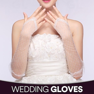 May include: White, fingerless wedding gloves with a delicate net pattern and lace trim. The gloves extend to the mid-forearm. The image also displays the text "WEDDING GLOVES" in white letters on a dark purple background.
