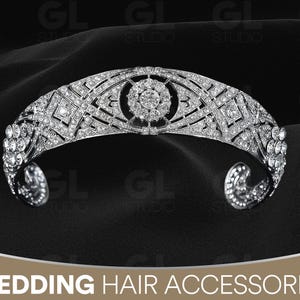 May include: A silver-toned tiara with intricate geometric and floral designs, encrusted with numerous sparkling crystals. The tiara is curved and has a central circular design. The words "WEDDING HAIR ACCESSORIES" are at the bottom.
