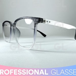 May include: Black and white eyeglasses with a clear frame and grey tinted lenses. The frame has a wood grain texture.