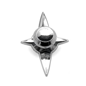 May include: A chrome-plated star-shaped knob with a round, smooth top. The knob is a decorative hardware piece.