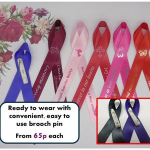 May include: Assortment of colourful satin ribbon with personalised messages and a silver angel, cross, praying hands, and butterfly design. Each ribbon has a brooch pin for easy attachment. From 65p each.