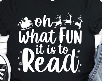 May include: Black t-shirt with white text that reads "Oh what fun it is to read" with a graphic of Santa Claus in a sleigh pulled by reindeer.