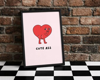 Könnte beinhalten: Gerahmter Kunstdruck mit einem Cartoon-roten Herz mit Beinen und Armen, das sich den Mund mit der Hand bedeckt. Der Text "CUTE ASS" befindet sich darunter auf rosa Hintergrund. Der Rahmen ist schwarz.