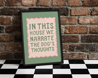 Könnte beinhalten: Gerahmtes Wandbild mit dem Text "IN THIS HOUSE WE NARRATE THE DOG'S THOUGHTS" in grünen Buchstaben auf einem rosa, wellenförmigen Hintergrund. Der schwarze Rahmen lehnt an einer Backsteinmauer.
