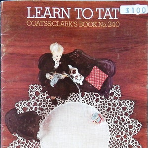 May include: A vintage book titled "Learn to Tat" by Coats & Clark's Book No. 240. The cover features a doll sitting on a sofa with a white doily on a wooden surface. The price is £1.00.
