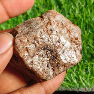 May include: A white ceramic mug with a black handle and the text "But First, Coffee" in a bold, black font. The mug is set against a neutral background, highlighting its simple design.
