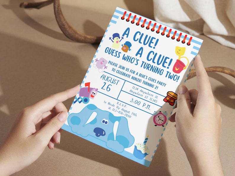 May include: A blue and white invitation card with the text "A Clue! A Clue! Guess Who's Turning Two!"  The invitation is for a Blue's Clues themed party on August 26th at 3:00 PM.