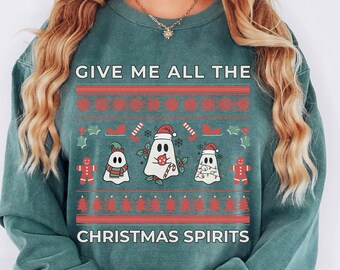 May include: Teal green Christmas sweater with a festive design featuring ghosts holding candy canes and the text "Give me all the Christmas Spirits".