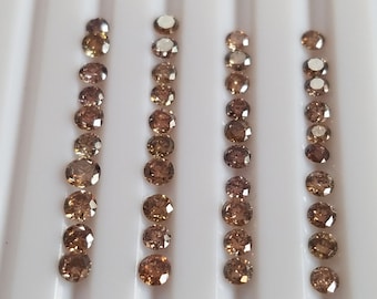 May include: A collection of 40 round, brown diamonds arranged in four rows of ten. The diamonds are displayed on a white background.