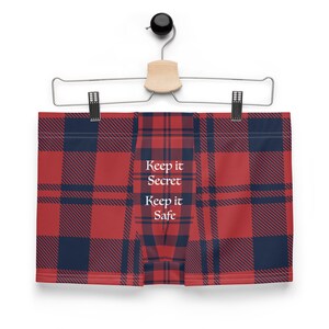 May include: Red and blue plaid boxer shorts with the text "Keep it Secret Keep it Safe" printed on the front.