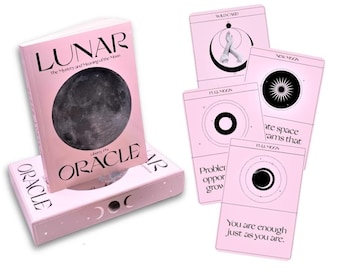 May include: A pink and black oracle deck called "Lunar Oracle" with a guidebook. The deck features illustrations of the moon in various phases. The guidebook has the title "Lunar: The Mystery and Meaning of the Moon".