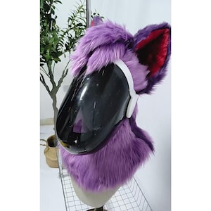 May include: Purple and red furry head with a black visor. The head is on a mannequin and is being displayed on a metal stand.