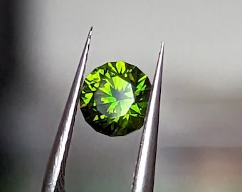 0.87 Demantoid Garnet with Horsetail inclusions Eye clean Exceptional deep green hexagonal color zone