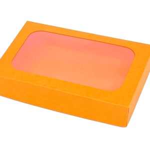 May include: Orange cardboard box with a clear window on the top. The box is empty.
