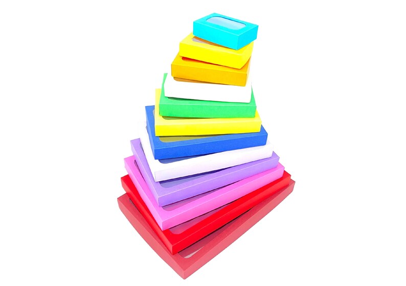 May include: A stack of colorful boxes with clear windows, arranged in a pyramid shape. The boxes are red, pink, purple, white, blue, yellow, green, and light blue.