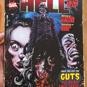 May include: Comic book cover for "Gates of Hell" featuring a gruesome illustration of a hanging figure and screaming faces. The cover includes text such as "City of the Living Dead" and "Have you got the guts to read this issue?"