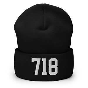 May include: Black beanie with a white embroidered number "718" on the cuff.