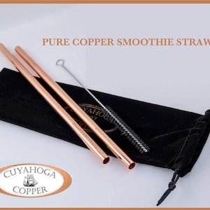May include: Two copper smoothie straws with a cleaning brush and a black velvet pouch. The straws are labelled "Cuyahoga Copper".