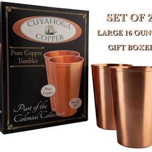 May include: A set of two 16-ounce copper tumblers with a smooth metallic finish. The packaging is a black box labeled Cuyahoga Copper, featuring a ship illustration, the text Part of the Colonial Collection, and a clear indication of a set of two.