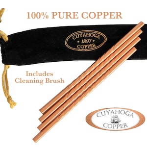 May include: Four copper straws with a black velvet carrying case and a cleaning brush. The text "100% PURE COPPER" is above the case, and the case has the text "CUYAHOGA 1897 COPPER". The cleaning brush is included.