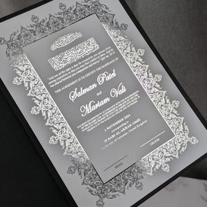 May include: A marriage certificate with silver filigree and text, including the names Salman Patel and Mariam Vali. The date is 1 November 2024, in Leicester, United Kingdom. The certificate is presented in a black folder with decorative borders.