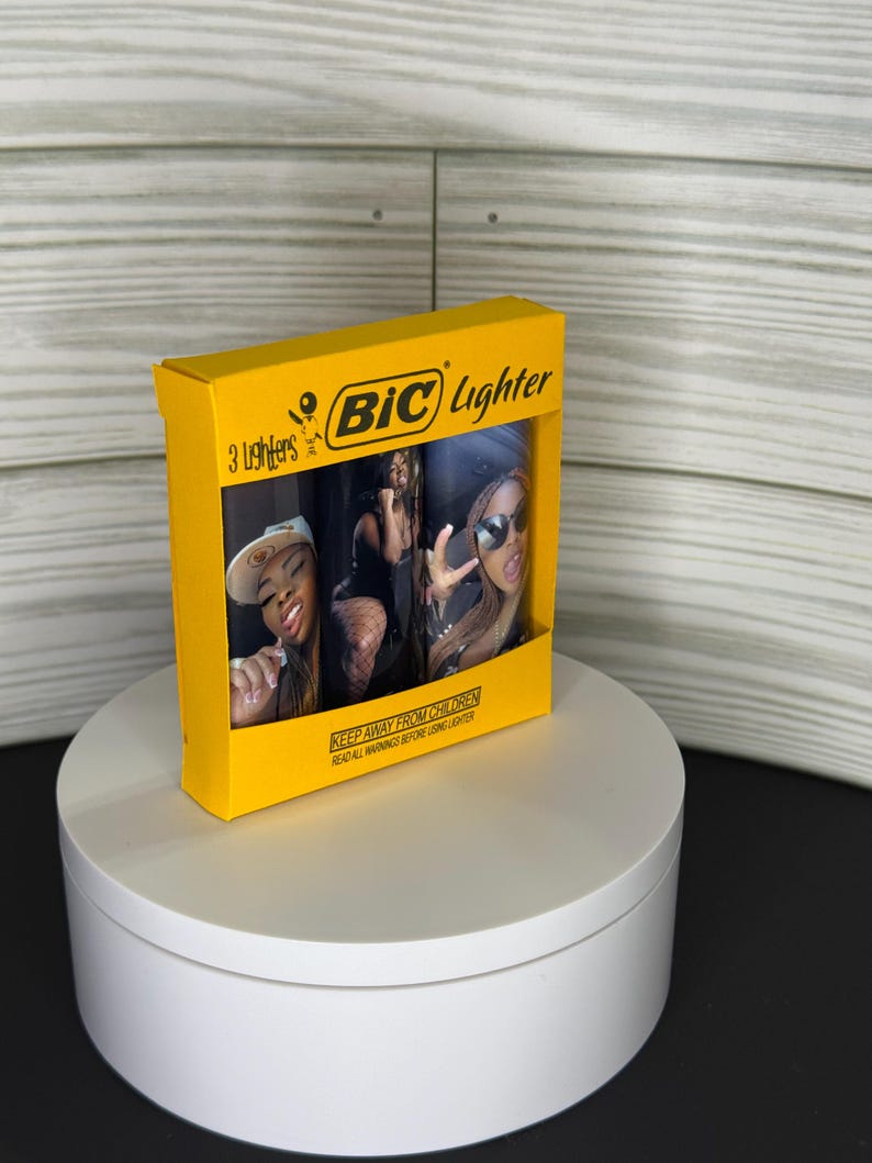 May include: A yellow box of BIC lighters featuring a photo of three women. The box reads "3 Lighters" and "BIC Lighter" in black text. The box also has the warning "KEEP AWAY FROM CHILDREN READ ALL WARNINGS BEFORE LIGHTING LIGHTER."