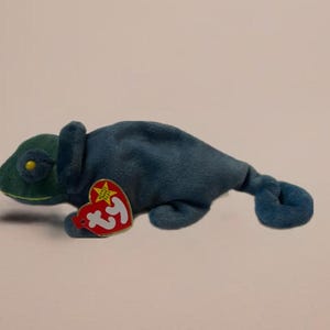 May include: A blue and green Ty Beanie Baby chameleon plush toy with a red tag that says "Ty" and has a star on it.