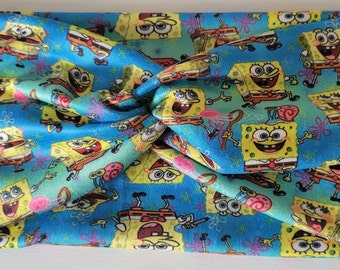 May include: A blue and green fabric headband with a repeating pattern of Spongebob Squarepants characters.