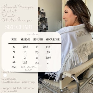 May include: White denim jacket with mixed fringe and white rhinestone detailing. The jacket has a size chart with measurements in inches for sleeve, length, and shoulder.