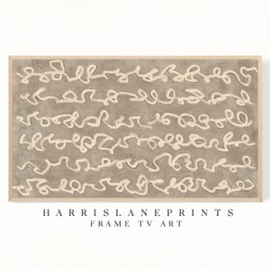 May include: Abstract art print with a beige background and white lines. The print is framed in a light wood frame. The text "HARRIS LANE PRINTS FRAME TV ART" is printed below the image.