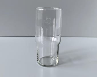 May include: A clear glass beer mug with a small logo etched on the side. The logo is a stylized design of a crown with the number 021 below it.