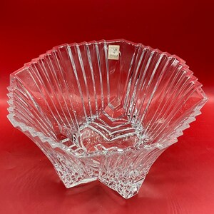 May include: A clear glass bowl with a starburst design. The bowl is made in France.