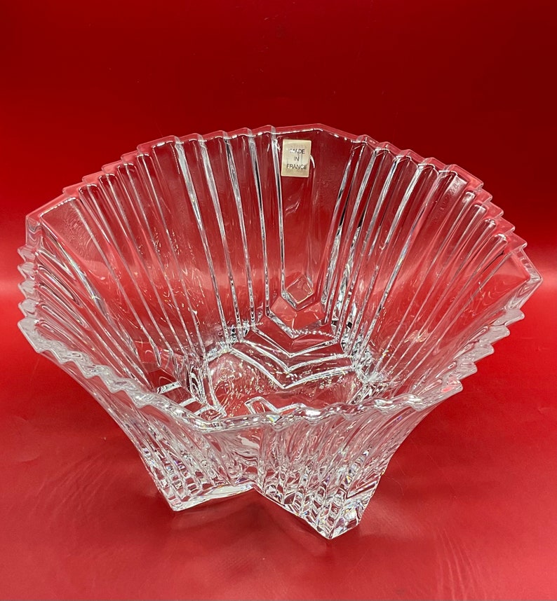 May include: A clear glass bowl with a starburst design. The bowl is made in France.