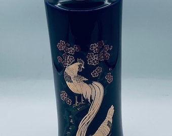 May include: A dark blue ceramic vase with a gold rim. The vase features a gold illustration of two roosters and cherry blossoms. The vase is approximately 10 inches tall.