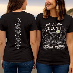 May include: A black t-shirt featuring a white graphic print. The front displays a margarita glass, lime, and a bottle labeled Witches Spirits with the text Put the Lime in the Coconut and Drink it All Up. The back shows a vertical column of icons.