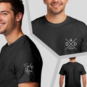 May include: Black t-shirt with white text. The left sleeve features the names "Emily Olivia" and a heart. The chest has a "DAD" design with "EST. 2024". A casual, everyday tee.
