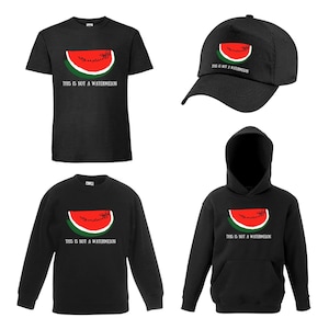 May include: A collection of black clothing items, including a t-shirt, cap, sweatshirt, and hoodie. Each item displays a watermelon slice graphic and the text "THIS IS NOT A WATERMELON." The watermelon design is red, green, and white.