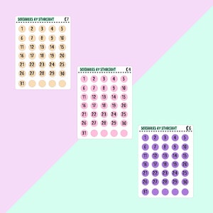 May include: Three printable calendar sticker sheets with the text "Scribbles by Starlight" and the numbers 1 through 31. The first sheet has beige circles, the second sheet has pink circles, and the third sheet has purple circles.