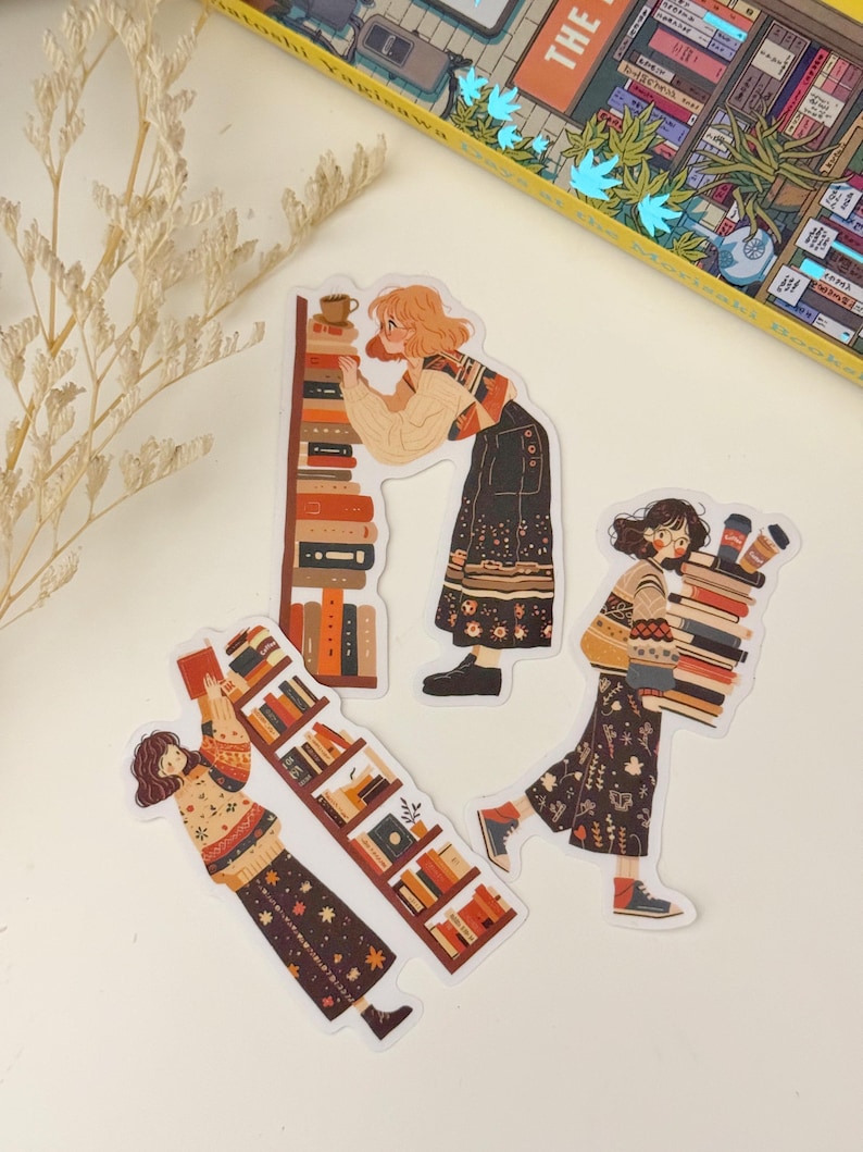 May include: Three illustrated stickers featuring women with books. The stickers are on a white background. The first sticker shows a woman in a brown and white sweater and skirt reaching for a book on a bookshelf. The second sticker shows a woman in a black and white dress holding a stack of books. The third sticker shows a woman in a brown and white sweater and skirt carrying a stack of books.
