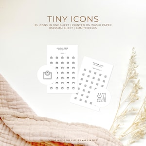 May include: Two sheets of white washi paper with black and white icons printed on them. The icons are in 8 mm circles. The sheets are labelled "KOLOUR CAFE 35 Tiny Icons" and "KOLOUR CAFE 35 Tiny Icons".