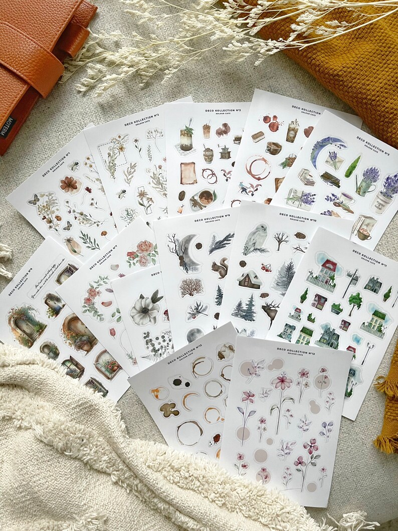 May include: A set of 10 sheets of watercolor stickers featuring various illustrations. The stickers include images of flowers, leaves, moons, owls, houses, and more. The stickers are printed on clear, glossy paper and are perfect for adding a touch of whimsy to your planner, journal, or scrapbook.