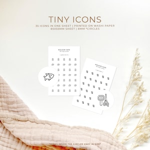 May include: Two sheets of white washi paper with black and white icons printed on them. The sheets are labeled "KOLOUR CAFE 35 Tiny Icons | Pet Care" and "KOLOUR CAFE 35 Tiny Icons | Pet Food". The icons are in 8 mm circles. The icons include a fish, a comb, and scissors.