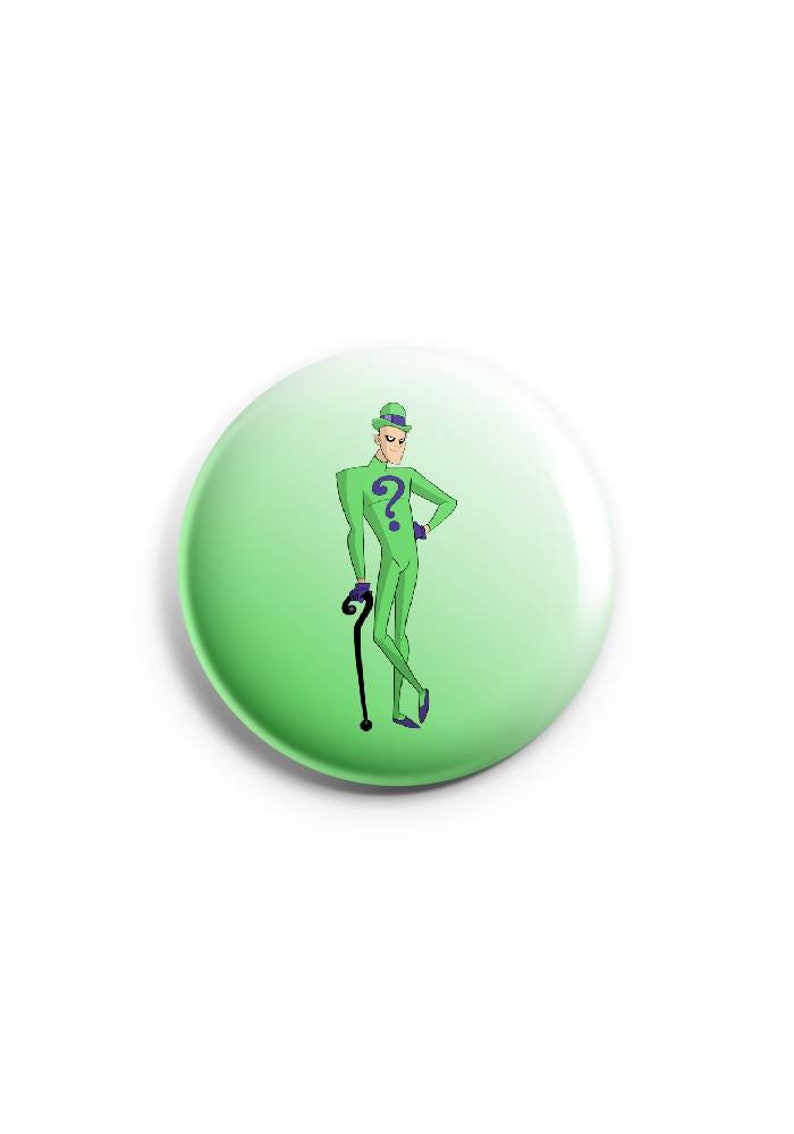 May include: A green button with a cartoon image of a man in a green suit with a question mark on the chest. The man is holding a cane and has a green hat on his head.