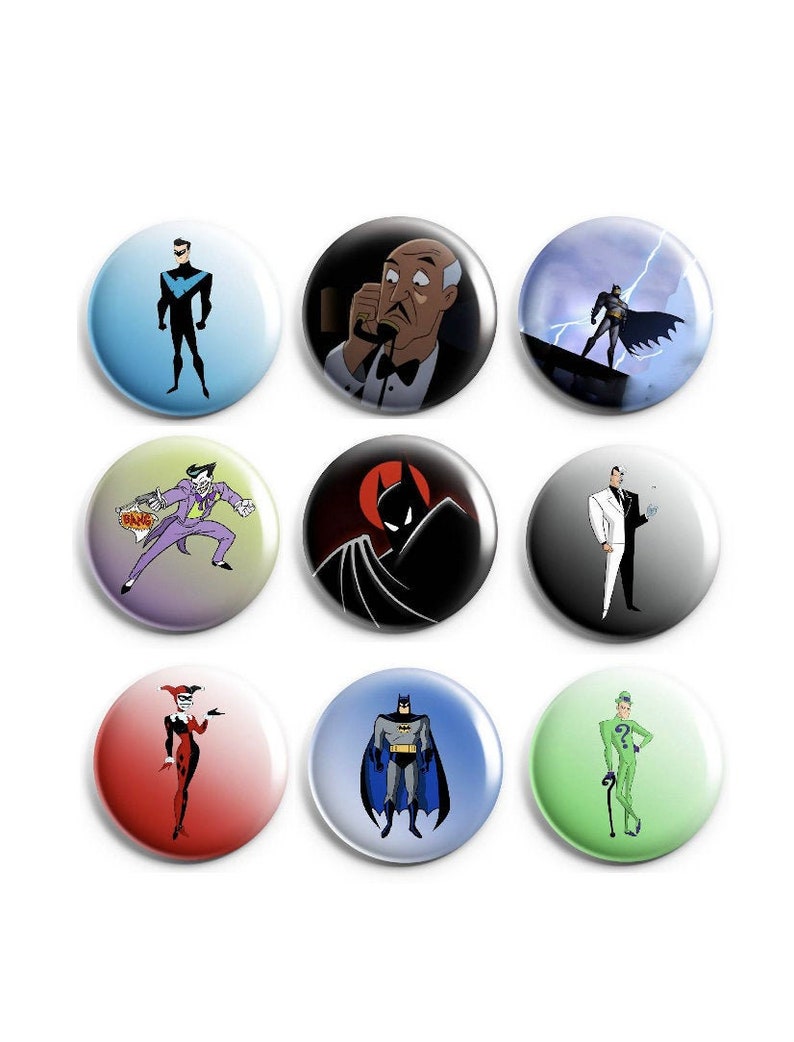 May include: Nine round button pins featuring characters from the Batman animated series. The pins feature characters such as Batman, Robin, The Joker, Harley Quinn, The Penguin, and Mr. Freeze. The pins are all different colors and have a glossy finish.