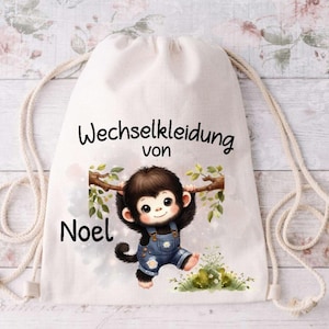 Könnte beinhalten: Weiße Kordeltasche mit einer Affenillustration und dem Text "Wechselkleidung von Noel".